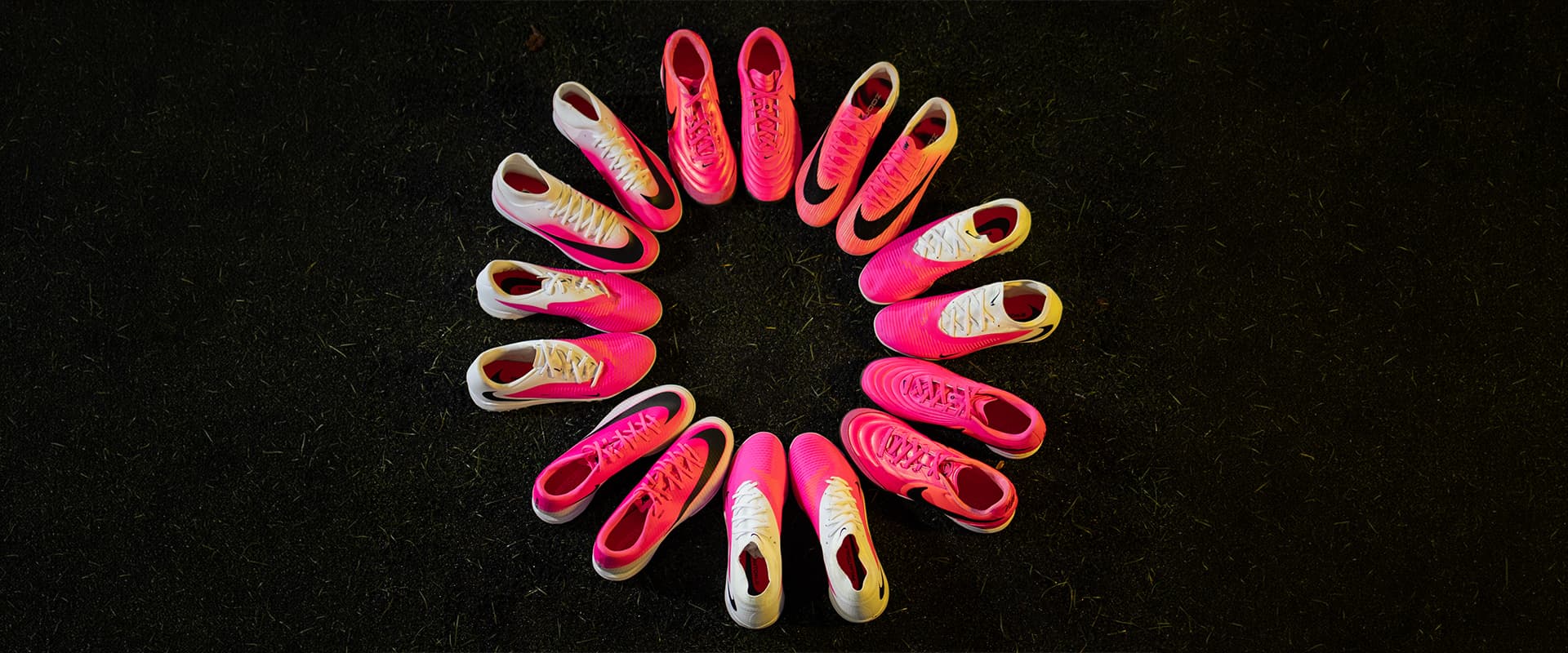 Nike football boot pack laid out on the pitch